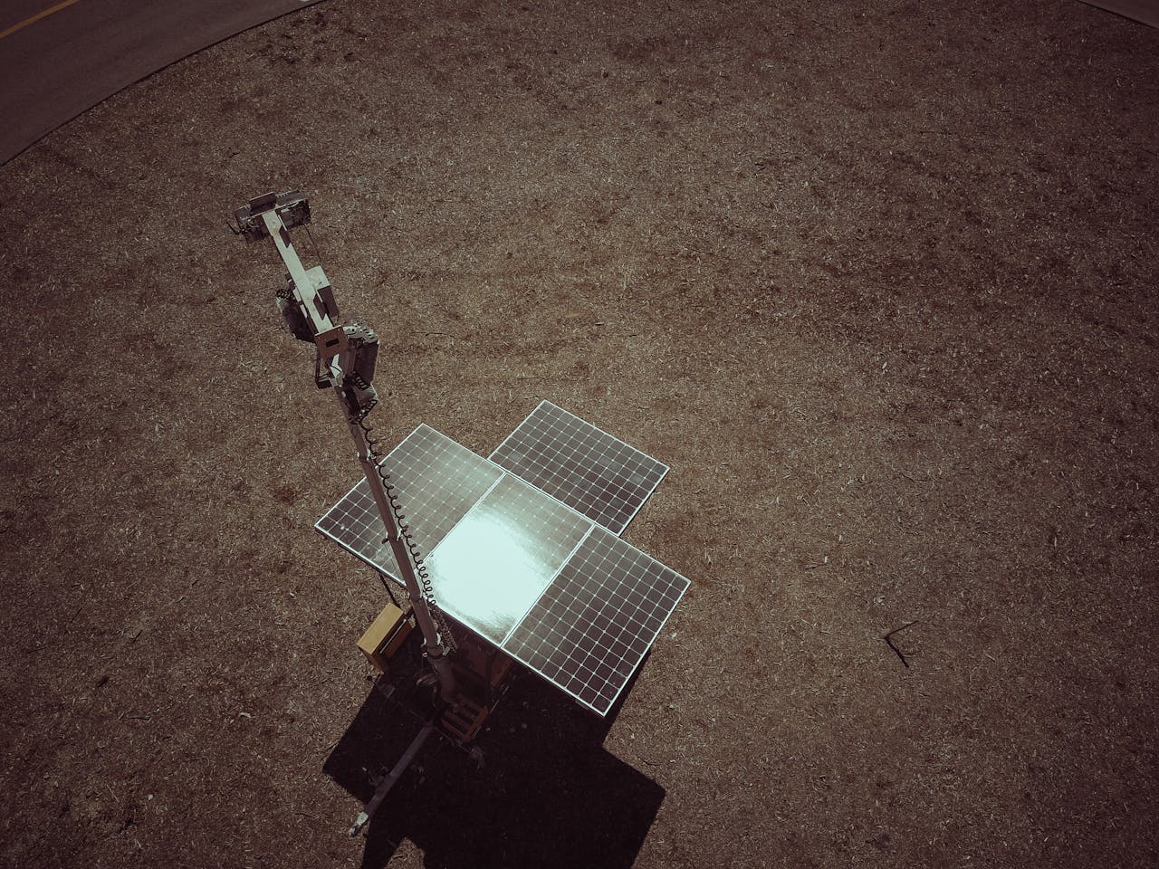 Drone view of solar panels on a dry and barren landscape emphasizing renewable energy.